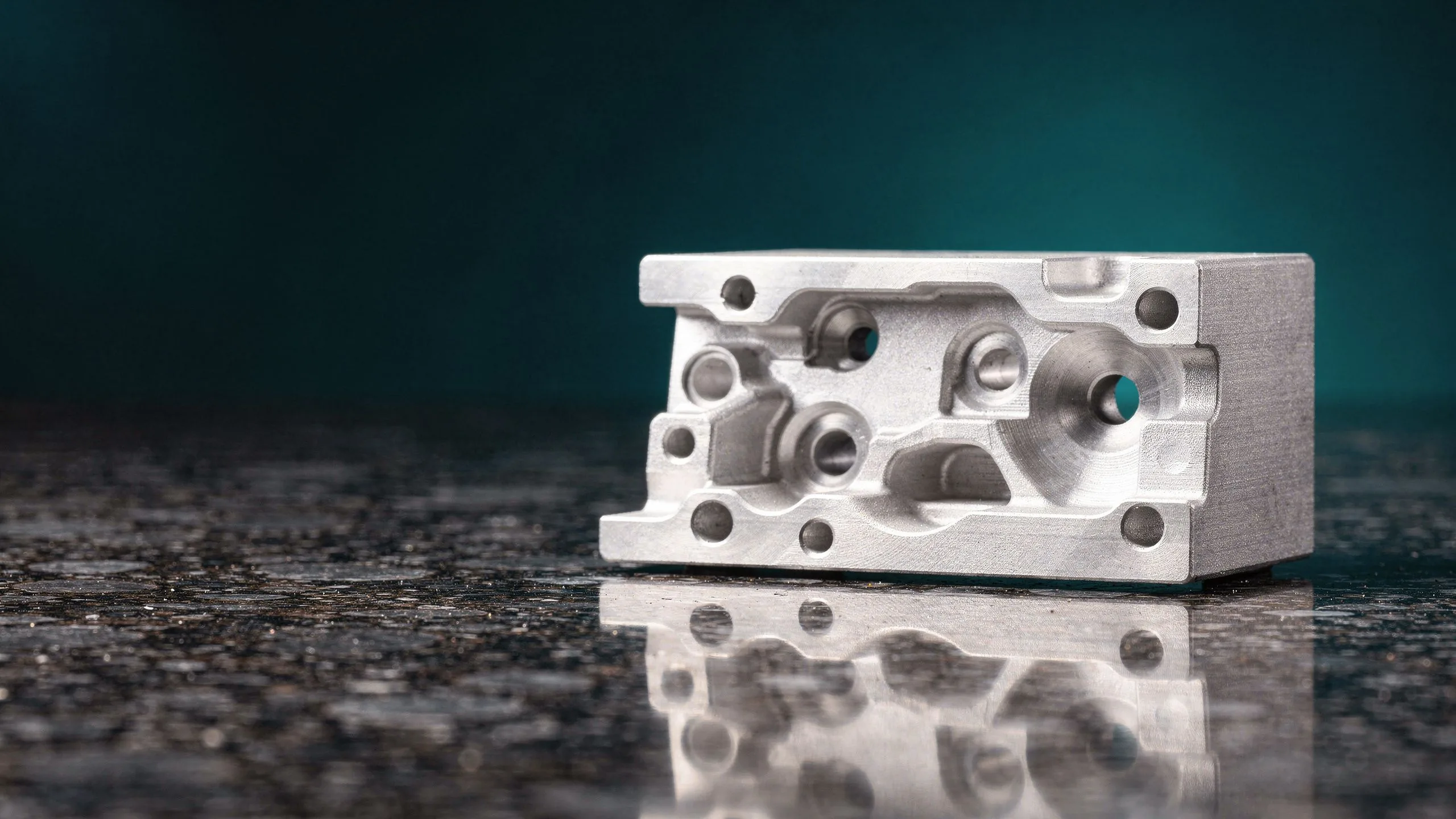 Precision-machined aluminum component on a granite inspection plate