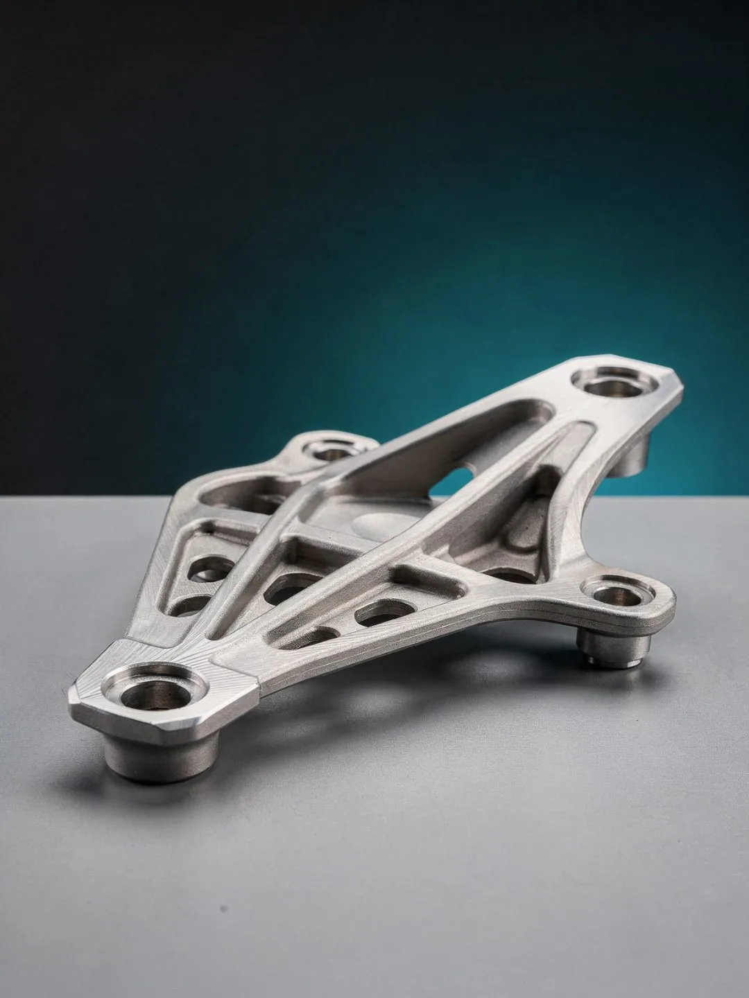 Machined titanium aerospace structural bracket with precision ribs and bored mounting holes