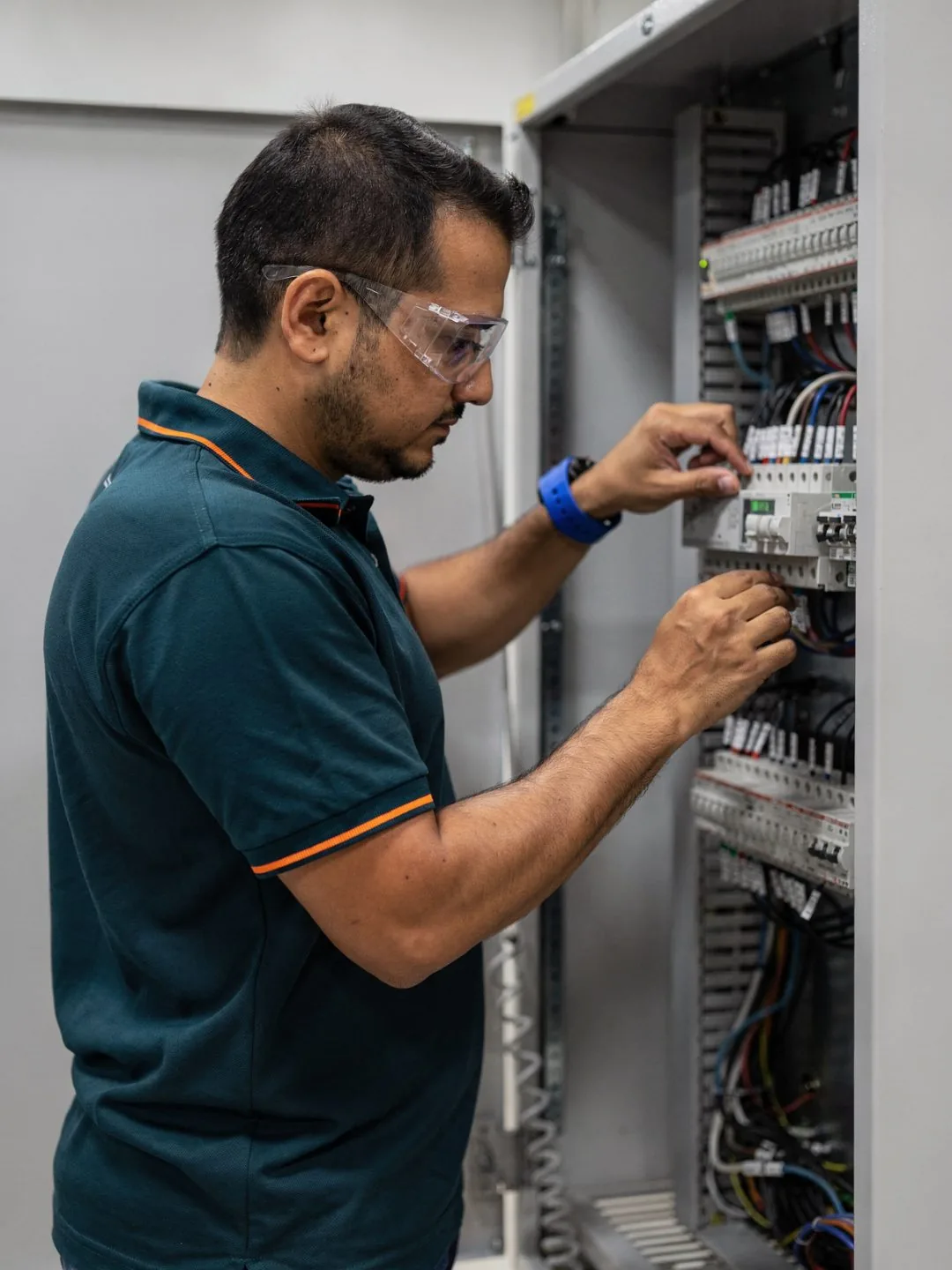 Technician building out a wired enclosure and cabinet assembly